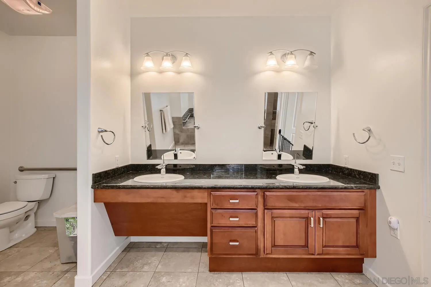 28553 Sunset Road Valley Center, CA 92082 - Photo 16 of 28 a bathroom with a granite countertop double vanity sink and a mirror