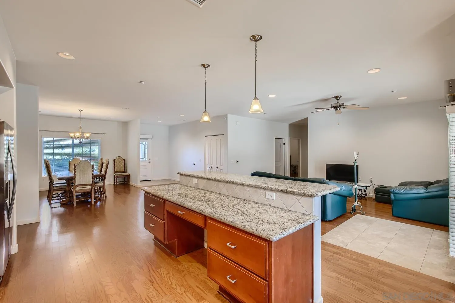 28553 Sunset Road Valley Center, CA 92082 - Photo 8 of 28 a kitchen with center island and stainless steel appliances