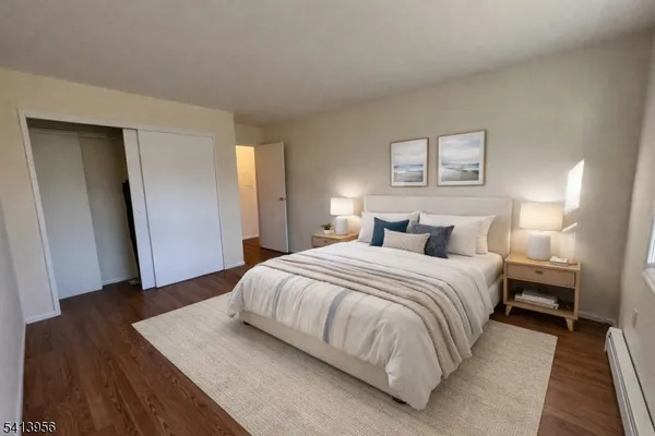 a bedroom with a bed and a night stand