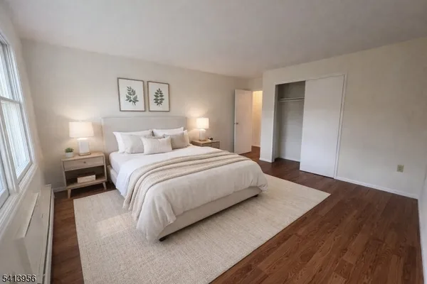 a bedroom with a bed and a night stand