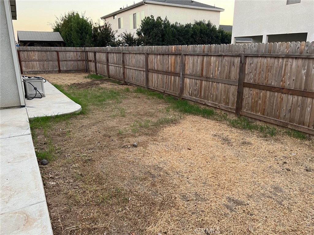 3751 Gabriel Drive Merced, CA 95340 - Photo 30 of 30 a view of a backyard with wooden fence