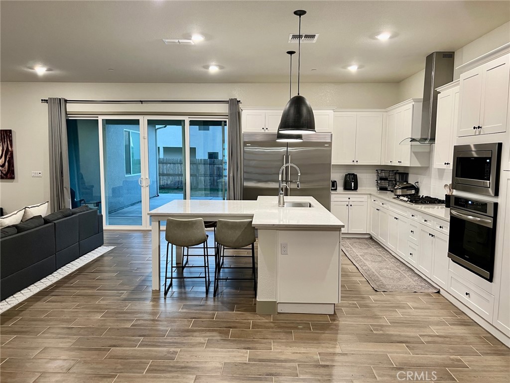 3751 Gabriel Drive Merced, CA 95340 - Photo 3 of 30 a kitchen with kitchen island a sink stainless steel appliances and dining table
