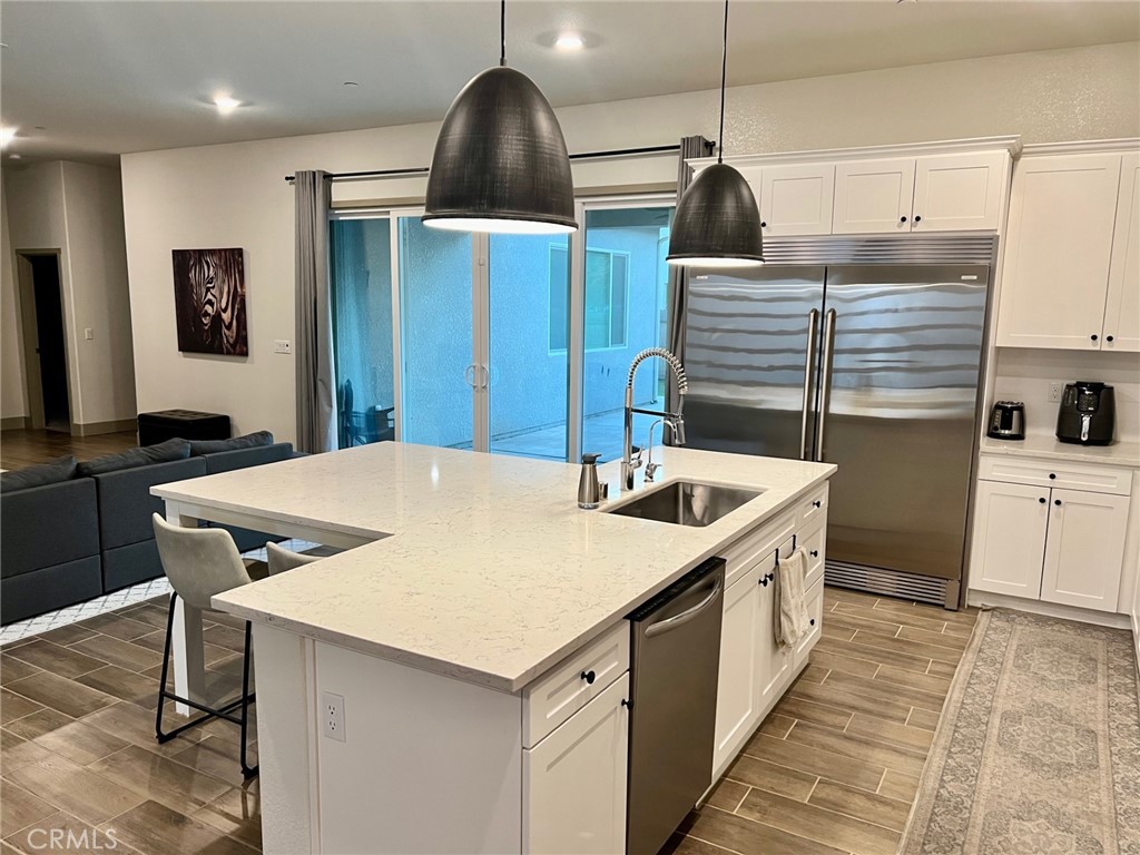 3751 Gabriel Drive Merced, CA 95340 - Photo 5 of 30 a kitchen that has a sink a stove and a wooden floor