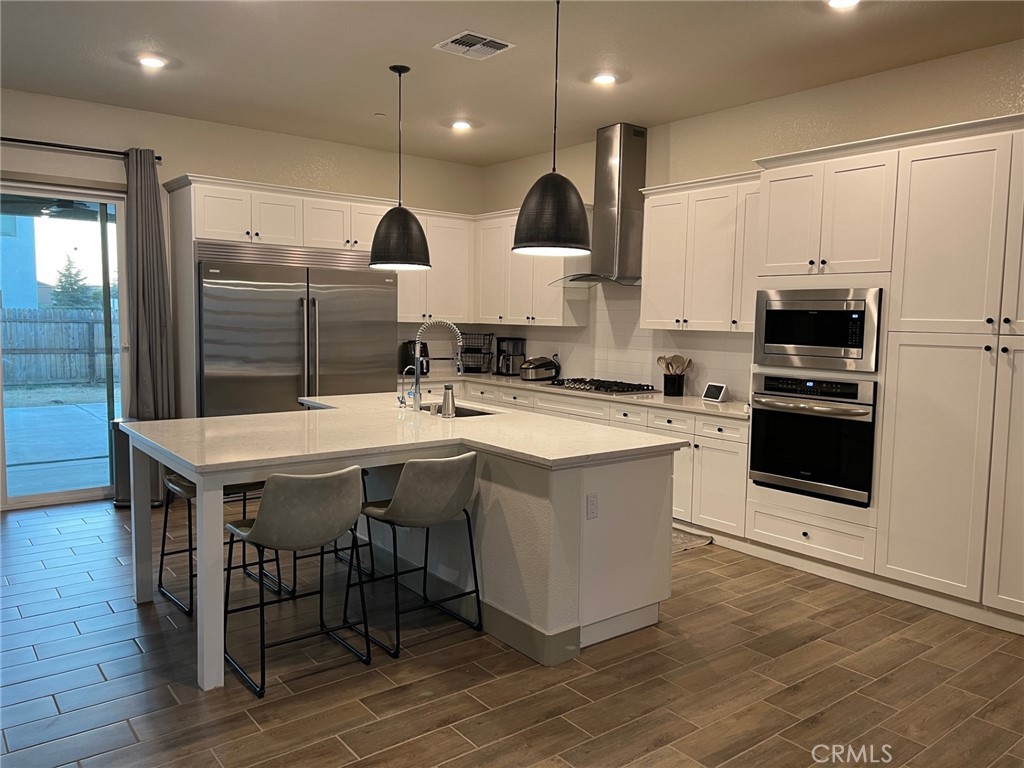 3751 Gabriel Drive Merced, CA 95340 - Photo 6 of 30 a kitchen with kitchen island stainless steel appliances a sink and a center island