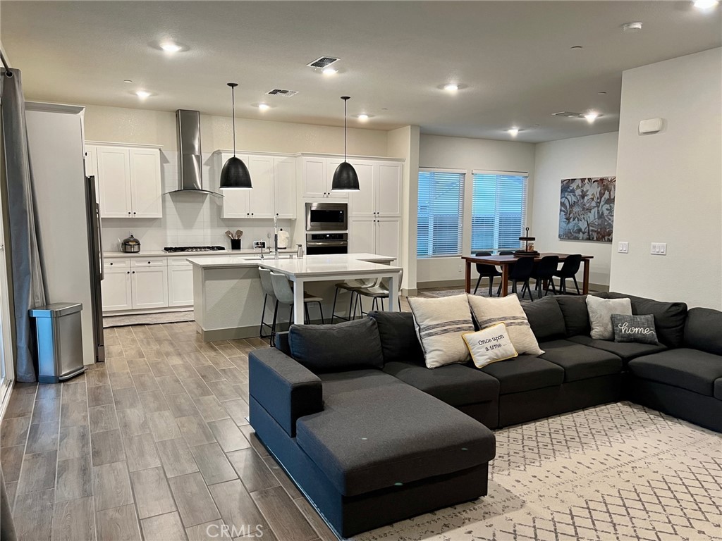 3751 Gabriel Drive Merced, CA 95340 - Photo 10 of 30 a living room with stainless steel appliances kitchen island granite countertop a couch and a view of living room