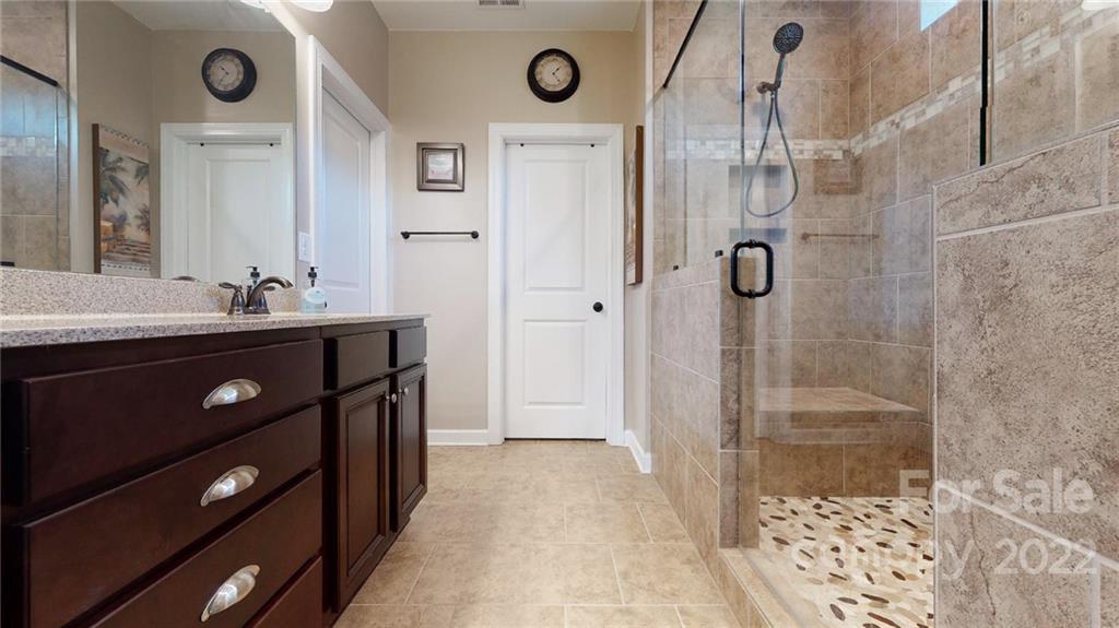 1137 Ellington Downs Way Monroe, NC 28110 - Photo 11 of 23 a bathroom with a sink a toilet a glass door shower and mirror