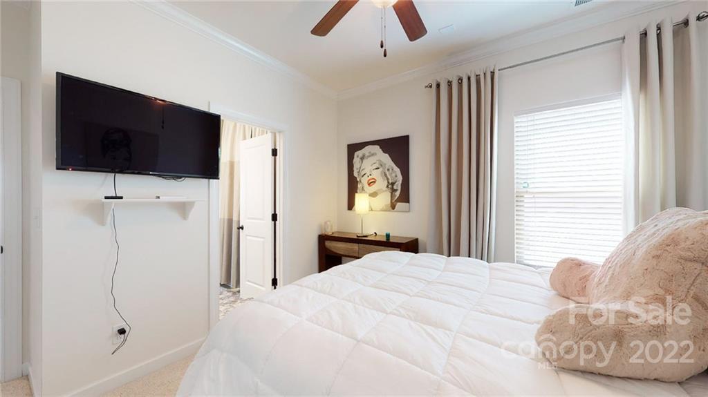 1137 Ellington Downs Way Monroe, NC 28110 - Photo 16 of 23 a bedroom with a large bed and a flat screen tv