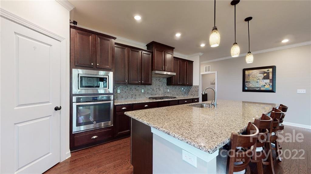 1137 Ellington Downs Way Monroe, NC 28110 - Photo 6 of 23 a kitchen with stainless steel appliances granite countertop a sink refrigerator and cabinets