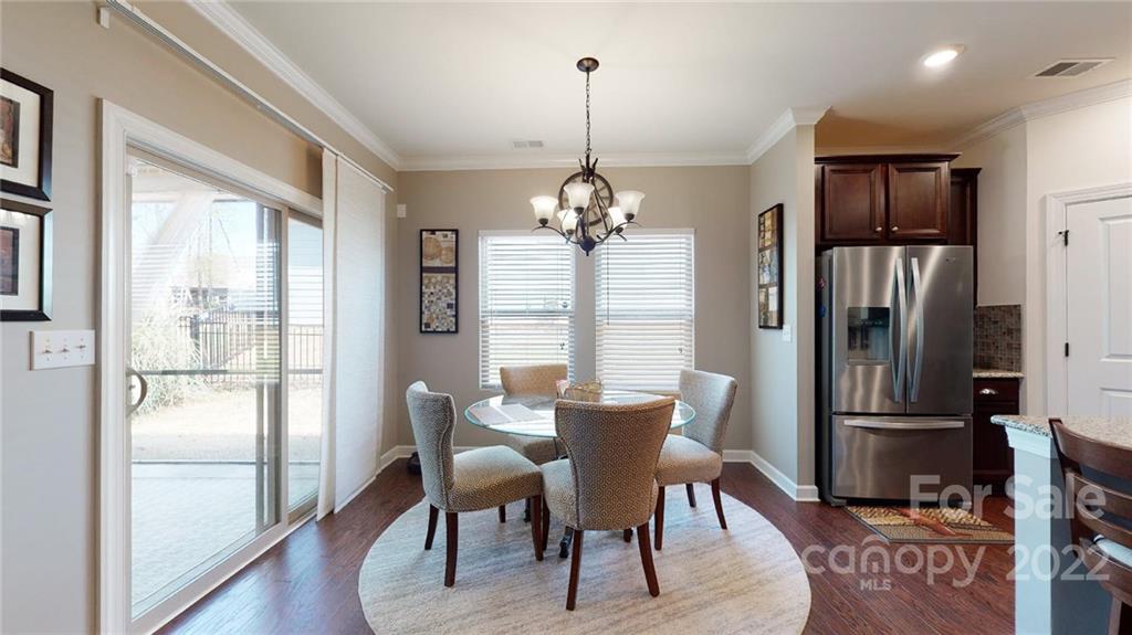 1137 Ellington Downs Way Monroe, NC 28110 - Photo 7 of 23 a dining room with furniture a chandelier and wooden floor