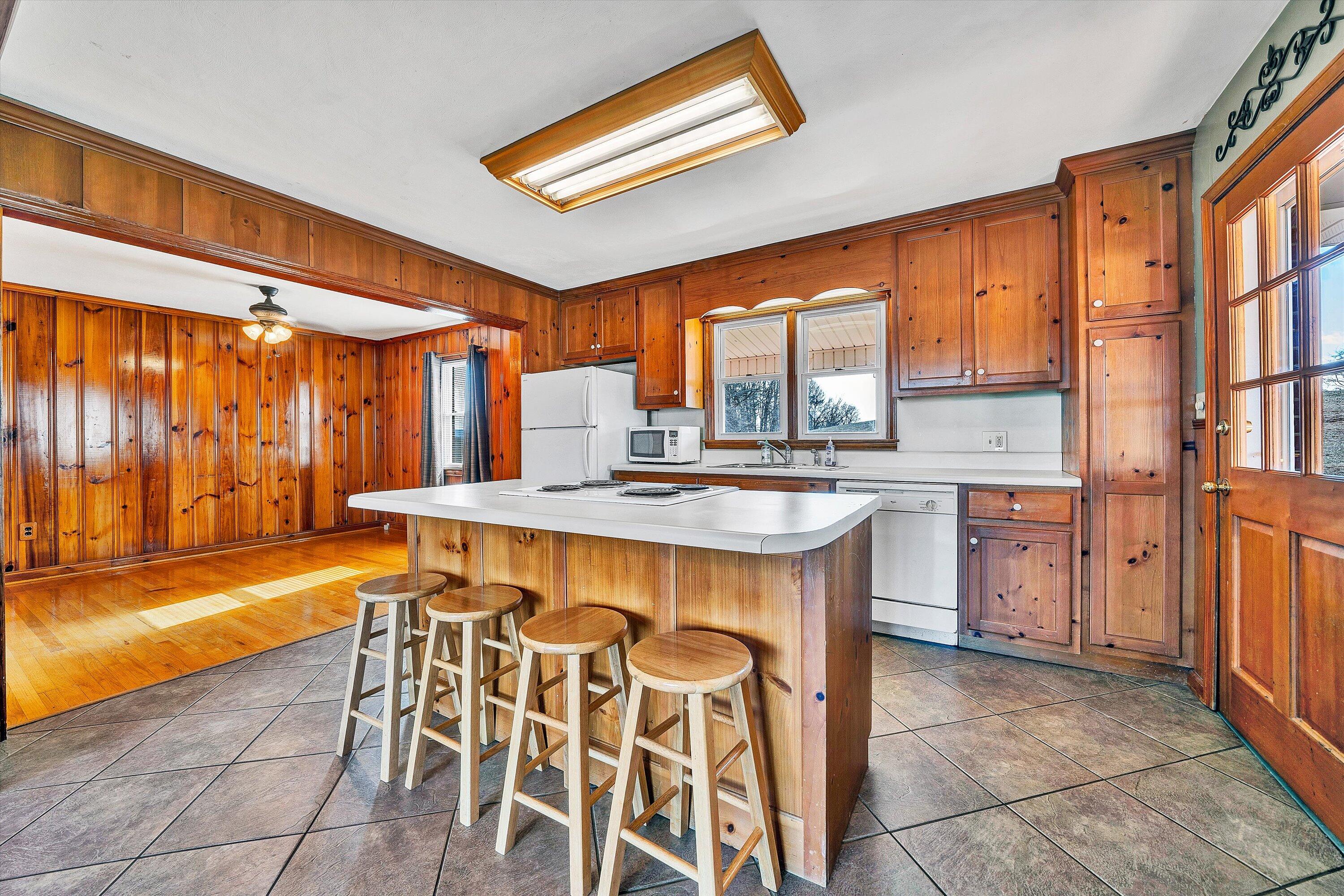 2483 Callaway Road Rocky Mount, VA 24151 - Photo 11 of 44 a dining hall with stainless steel appliances granite countertop a stove a sink and a microwave