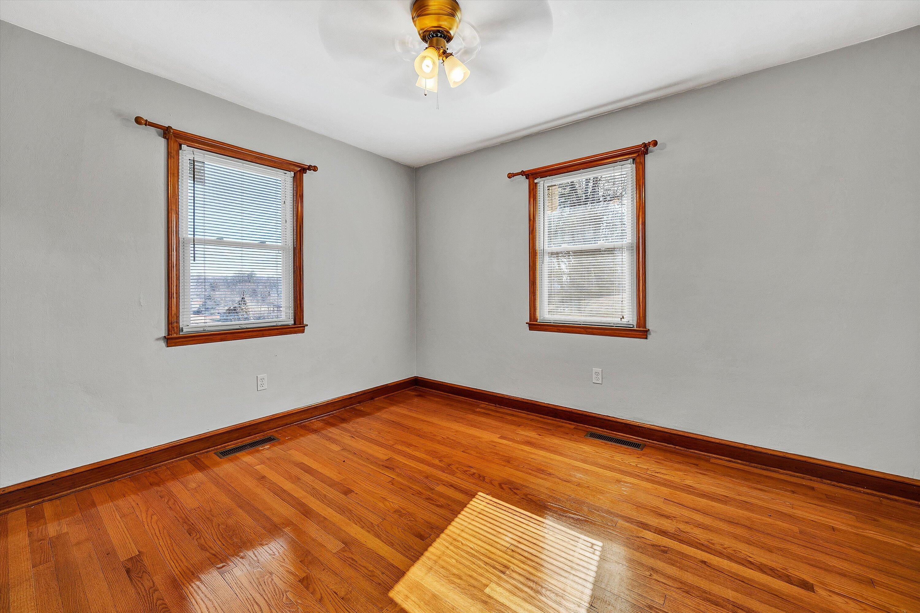 2483 Callaway Road Rocky Mount, VA 24151 - Photo 19 of 44 a view of an empty room with wooden floor and a window