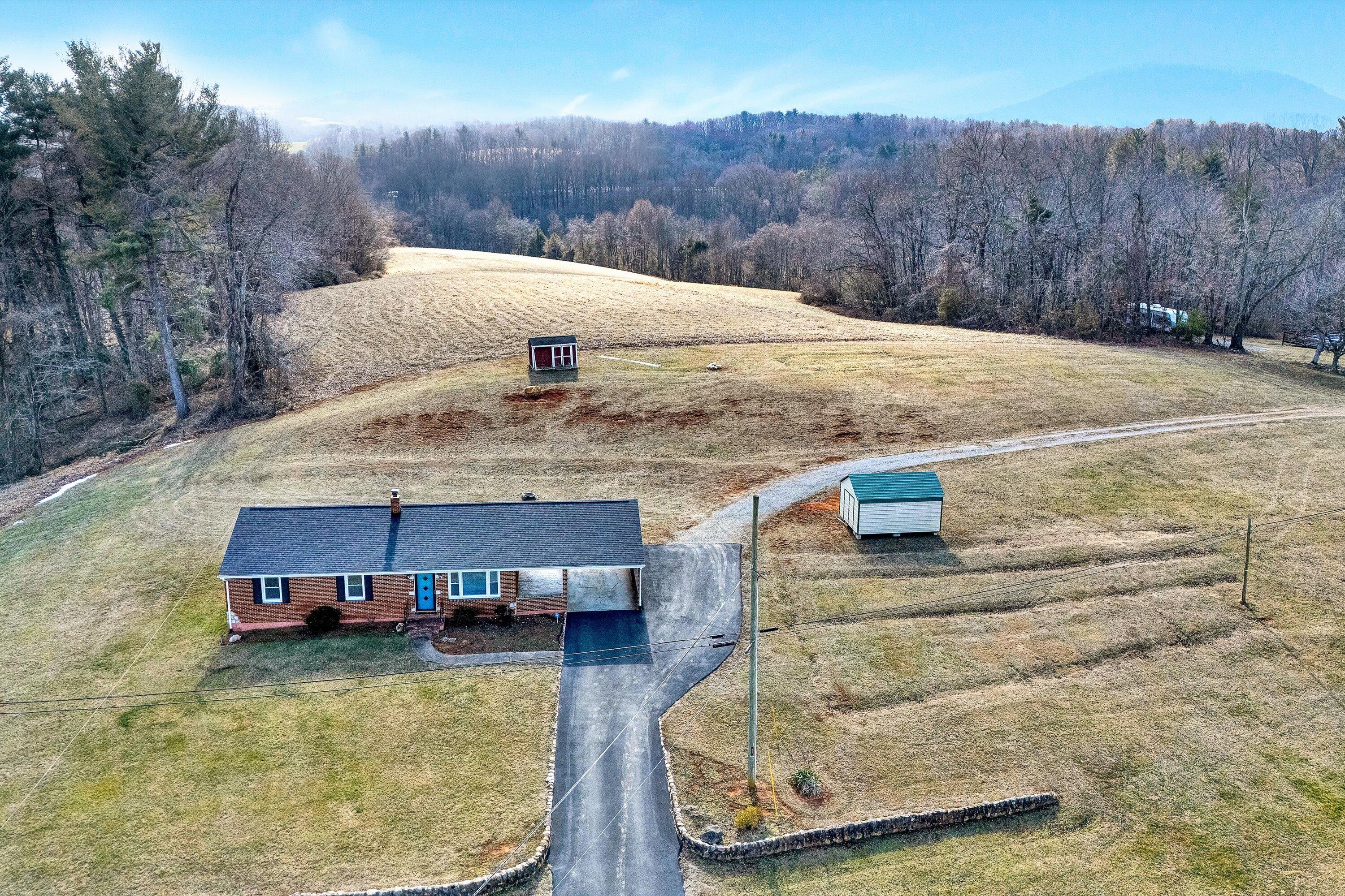 2483 Callaway Road Rocky Mount, VA 24151 - Photo 2 of 44 a view of a swimming pool with a yard and mountain view