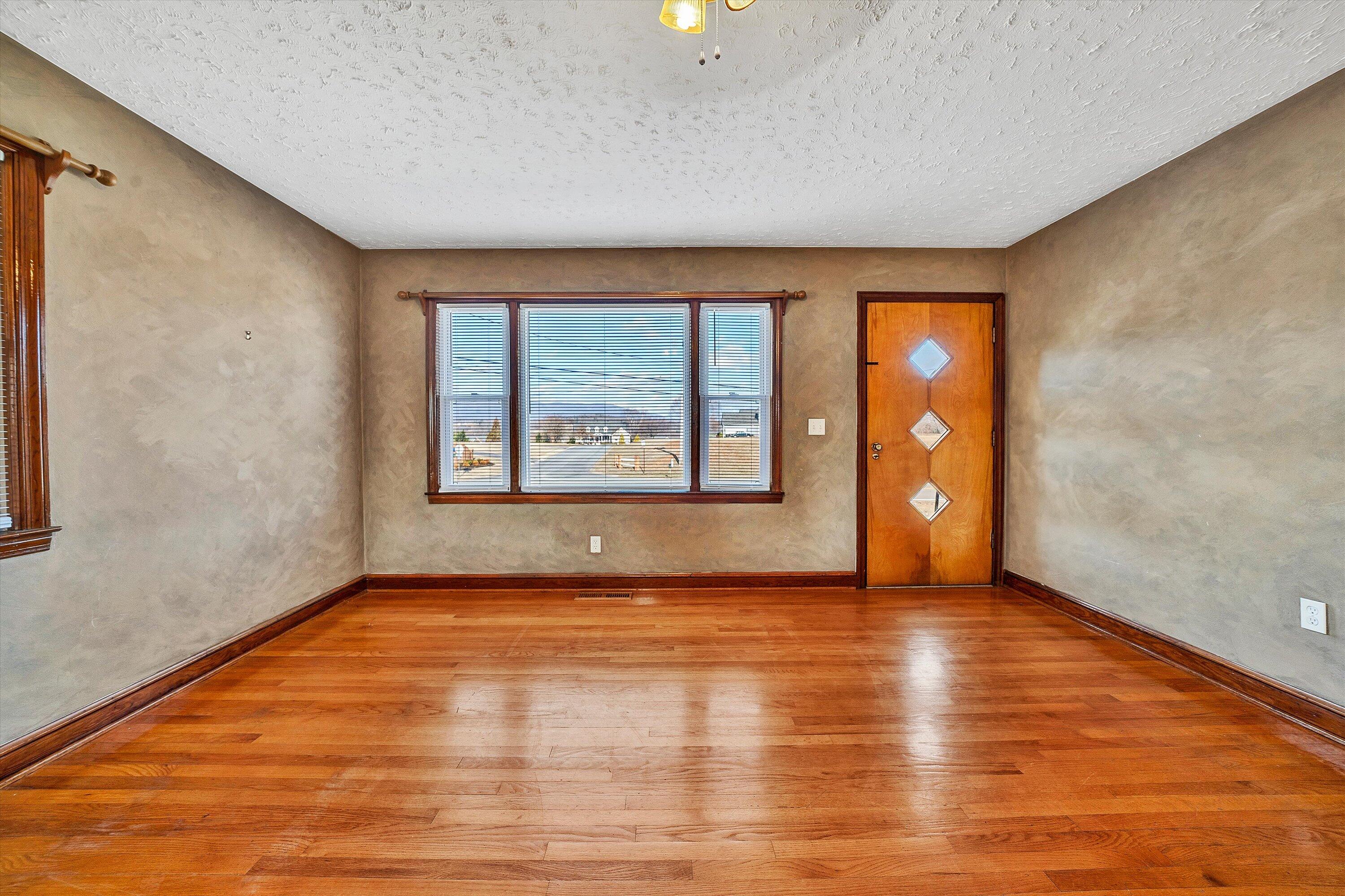 2483 Callaway Road Rocky Mount, VA 24151 - Photo 6 of 44 a view of an empty room with window and wooden floor