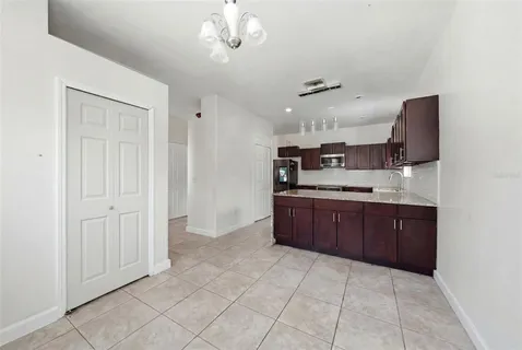 a large kitchen with a cabinets and stainless steel appliances