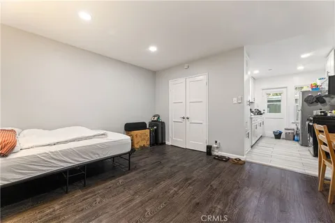a bedroom with a bed window and a table