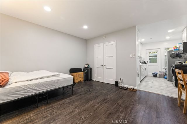 a bedroom with a bed window and a table