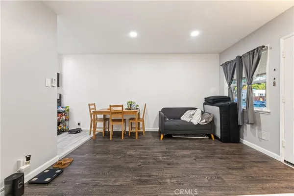 a spacious bedroom with a bed and wooden floor