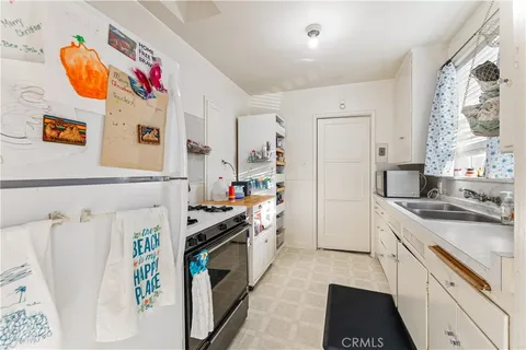 a kitchen that has a sink and a stove
