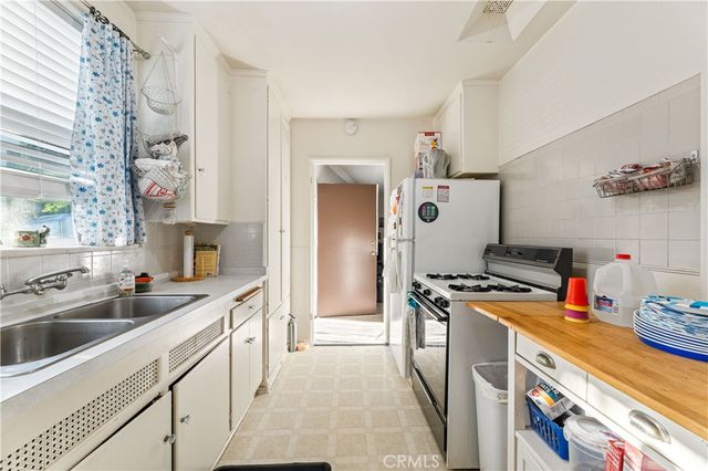 a kitchen with a sink and a stove top oven