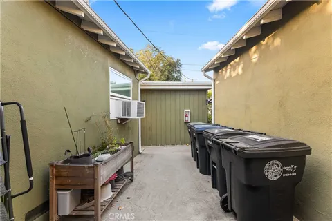 a view of a backyard with table and chairs under an umbrella
