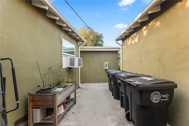 a view of a backyard with table and chairs under an umbrella