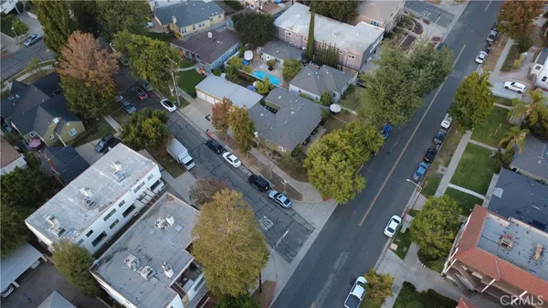an aerial view of a house with a mountain