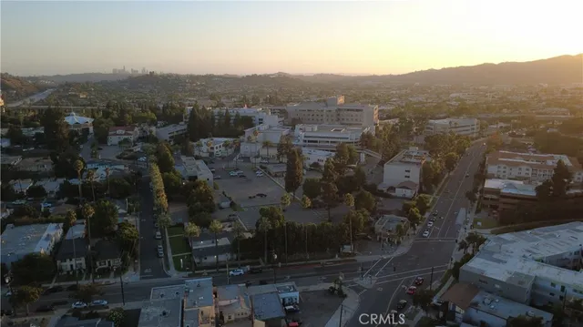 an aerial view of residential houses with city view