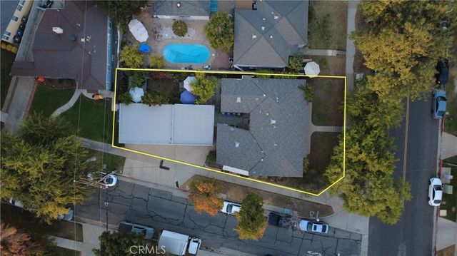 an aerial view of a house with a yard