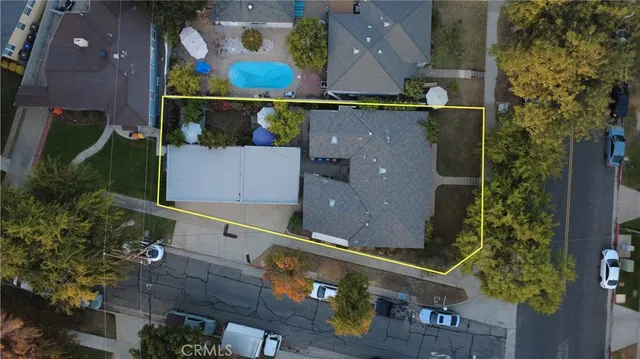 an aerial view of a house with a yard