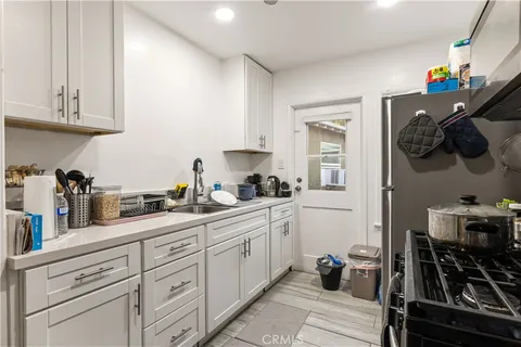 a kitchen with stainless steel appliances a sink stove and cabinets