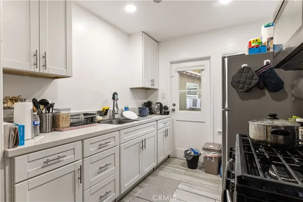 a kitchen with stainless steel appliances a sink stove and cabinets