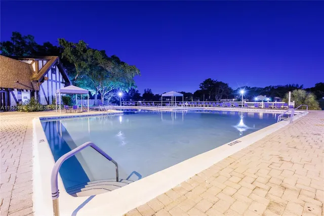 a view of a swimming pool with seating space