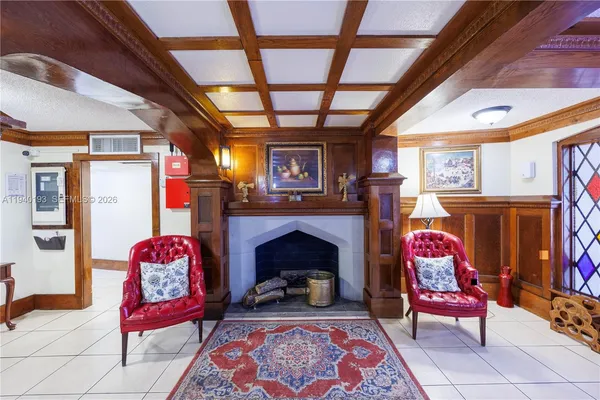 a living room with furniture fireplace and rug