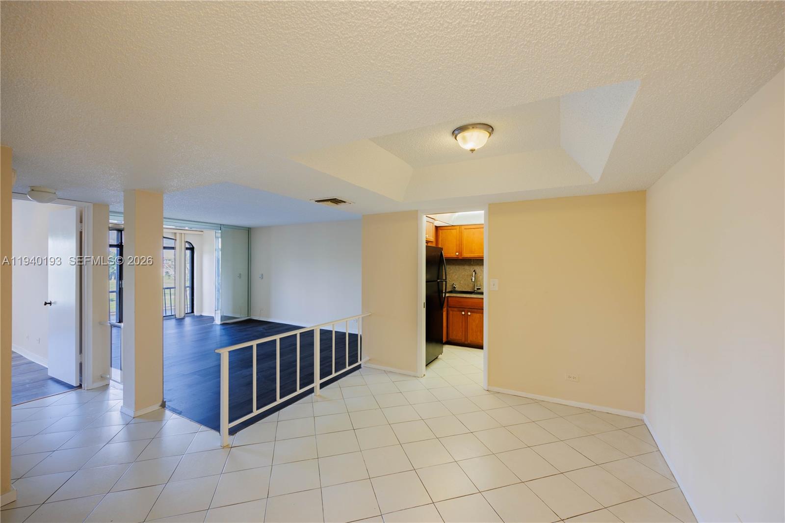 3760 Inverrary Drive, Unit 3D Lauderhill, FL 33319 - Photo 2 of 22 a view of an empty room with kitchen and a window