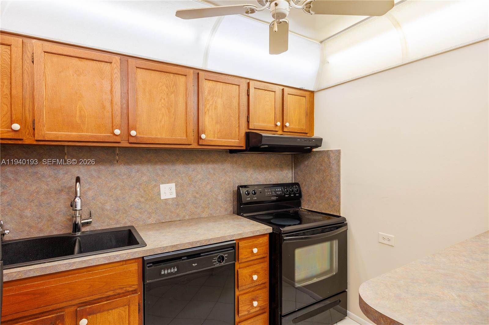 3760 Inverrary Drive, Unit 3D Lauderhill, FL 33319 - Photo 5 of 22 a kitchen with stainless steel appliances granite countertop a sink a stove and a microwave