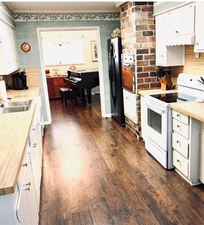 a kitchen with stainless steel appliances granite countertop a stove and a refrigerator