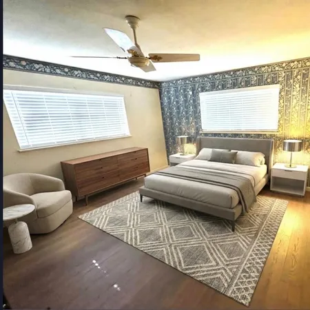 a bedroom with furniture and a large window
