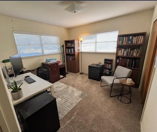 a workspace with furniture and a bookshelf