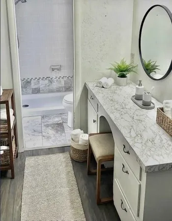 a bathroom with a granite countertop sink and a mirror