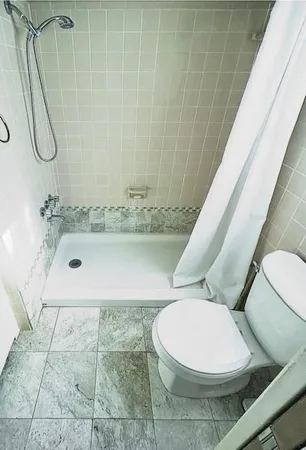 a bathroom with a toilet and shower