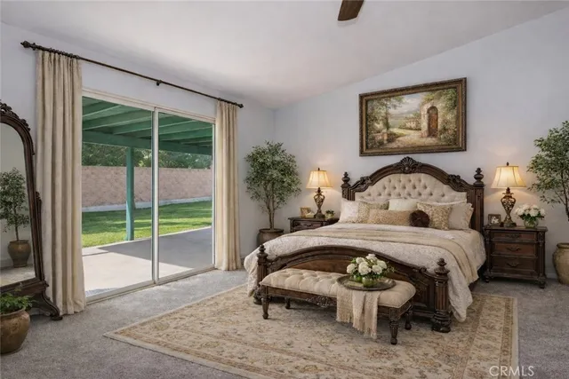 a bedroom with a bed a mirror and a large window