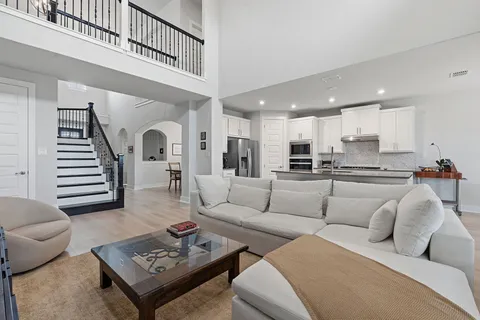 a kitchen with stainless steel appliances a kitchen island hardwood floor sink and stove