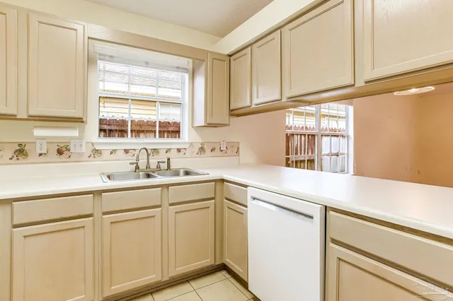 a kitchen with white cabinets and white appliances