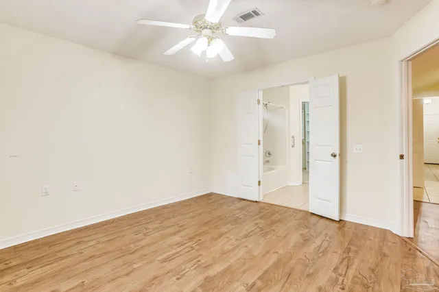 an empty room with fan and a ceiling fan