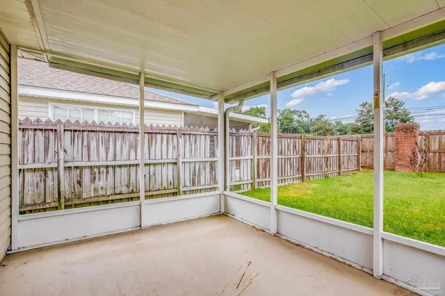 a view of backyard with large trees and plants
