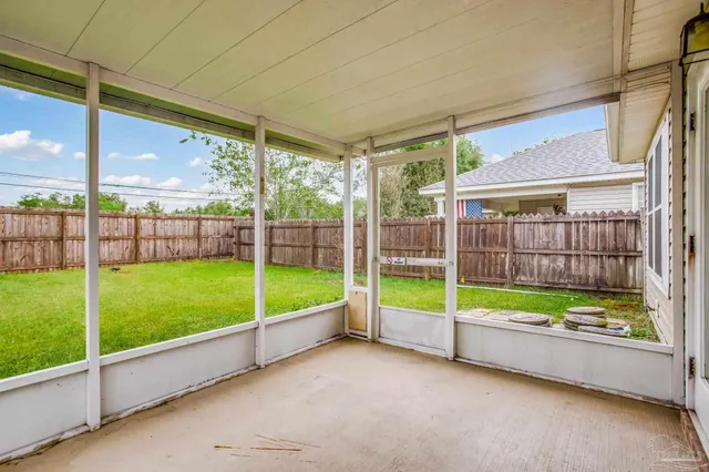 a view of a backyard with porch and garden