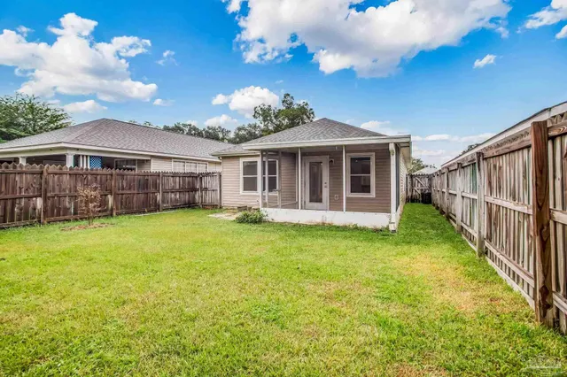 a view of a house with a backyard
