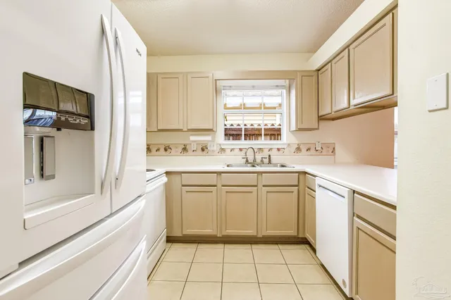 a kitchen with a sink window and cabinets