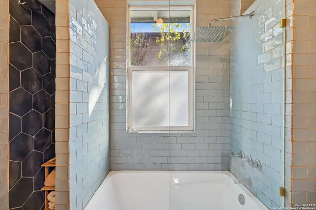 a bathroom with a bathtub and shower