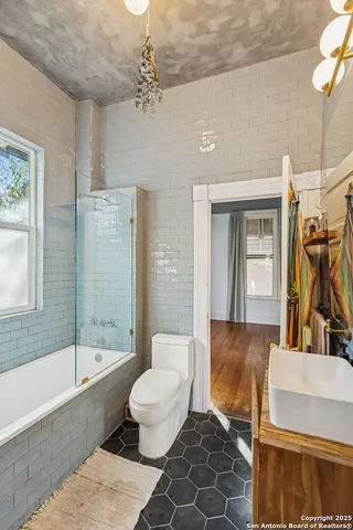 a bathroom with a sink toilet and shower